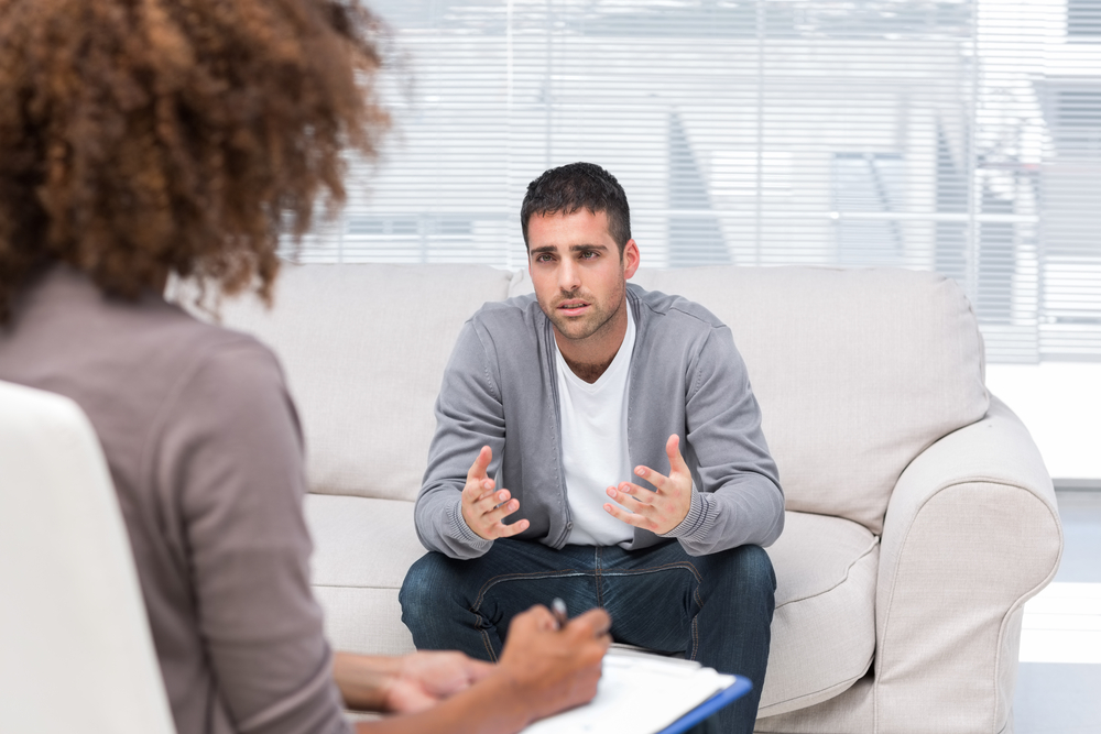 Man in a private therapy session with a licensed counselor