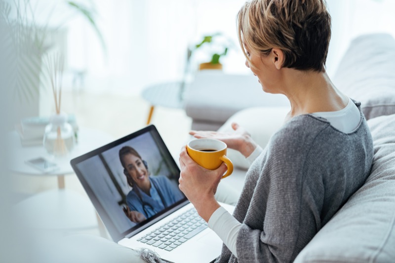 Woman using LiveWell platform on her laptop at home